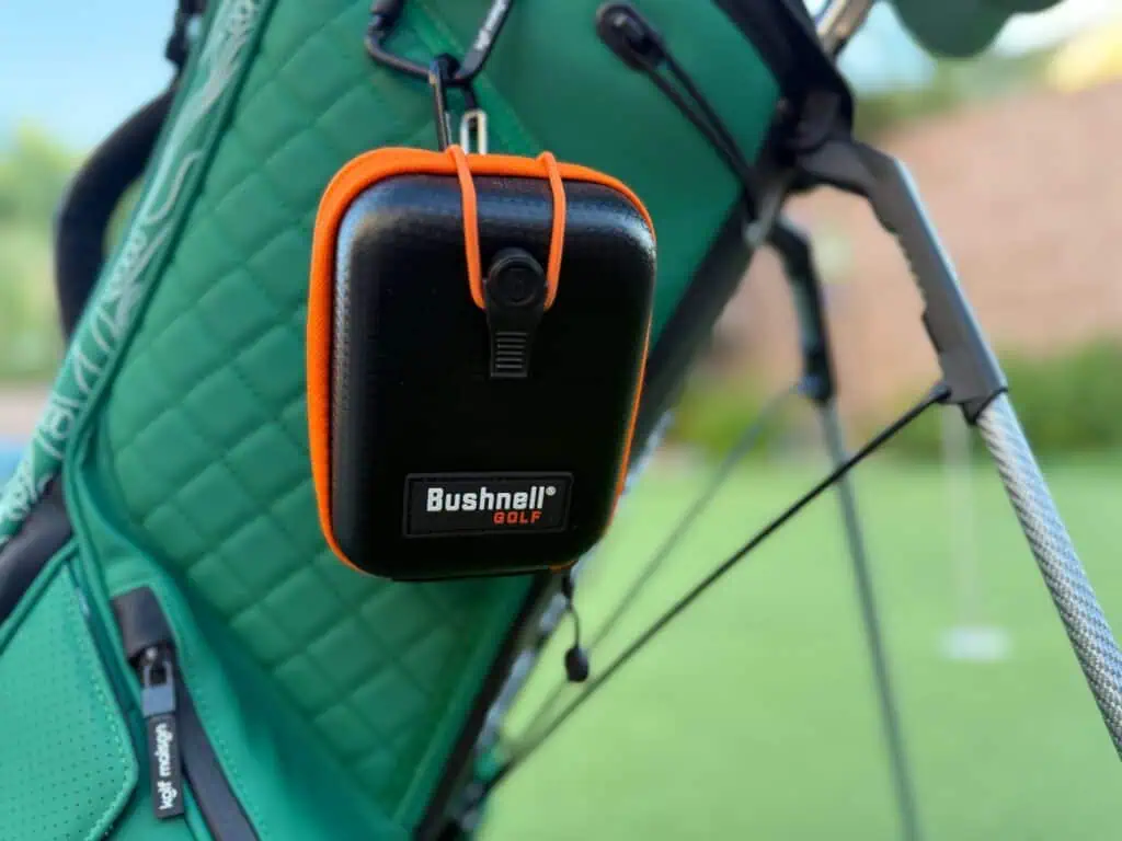 Bushnell hard case clipped to a golf bag