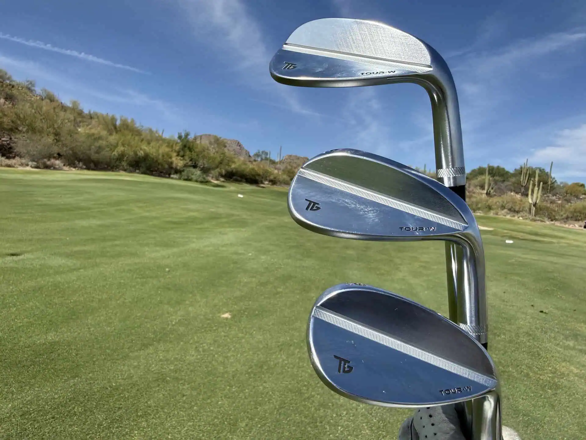 Three Tour-W wedges lined up on the course