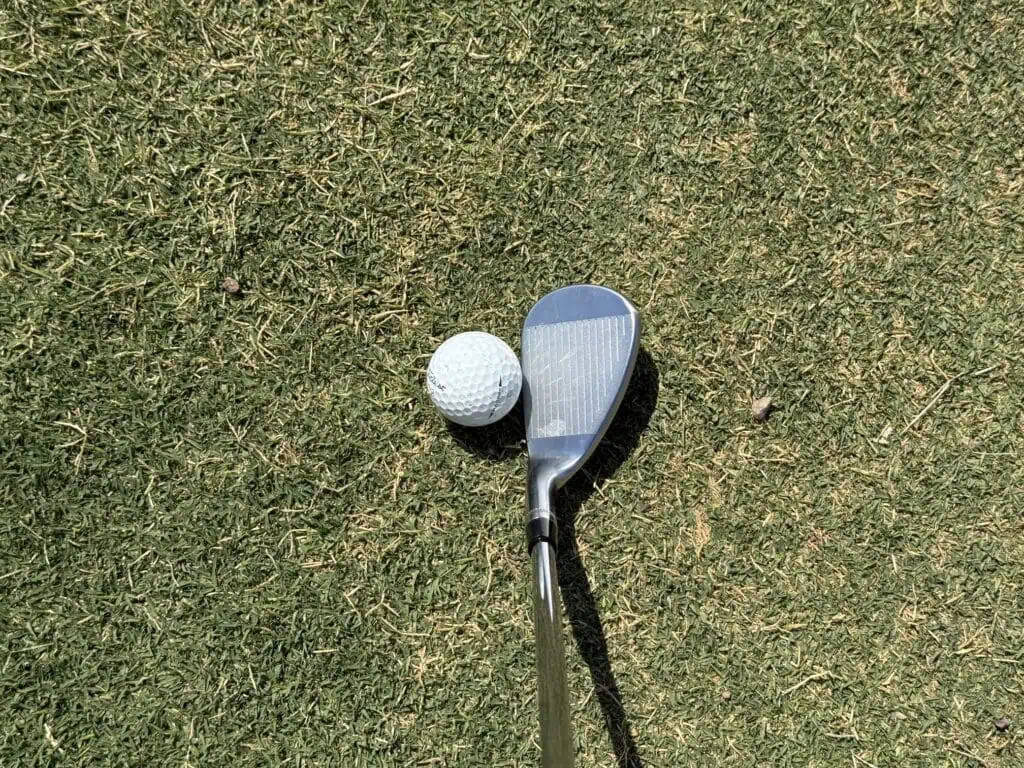 K-grind Tour-W wedge at address behind the ball