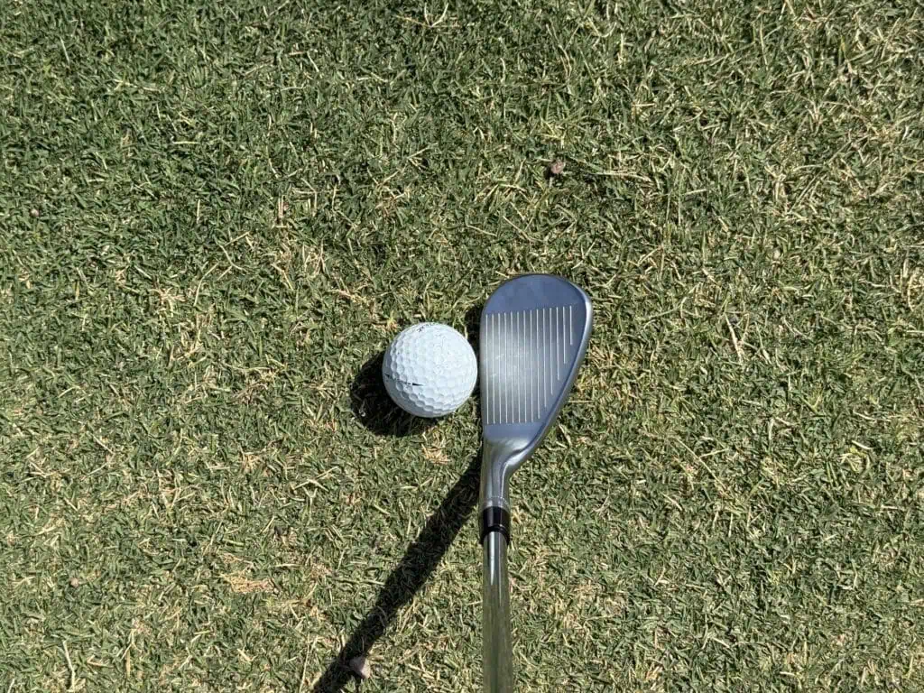 F-grind Tour-W wedge at address behind the ball