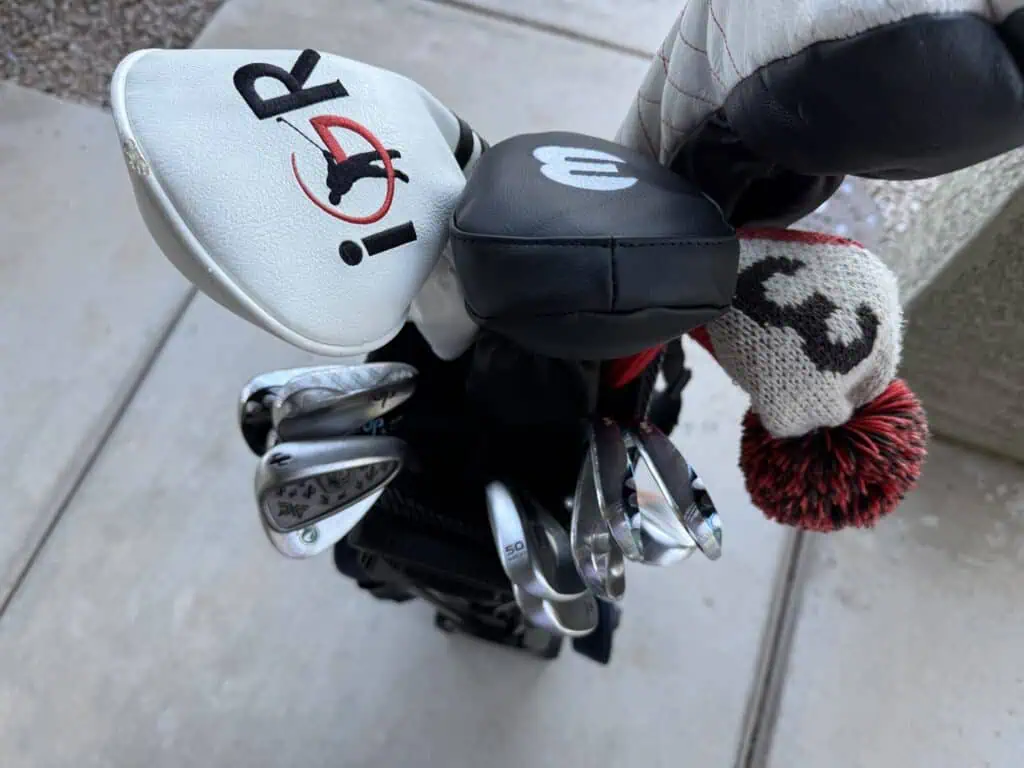 Woods with headcovers and irons organized in the 7-way top